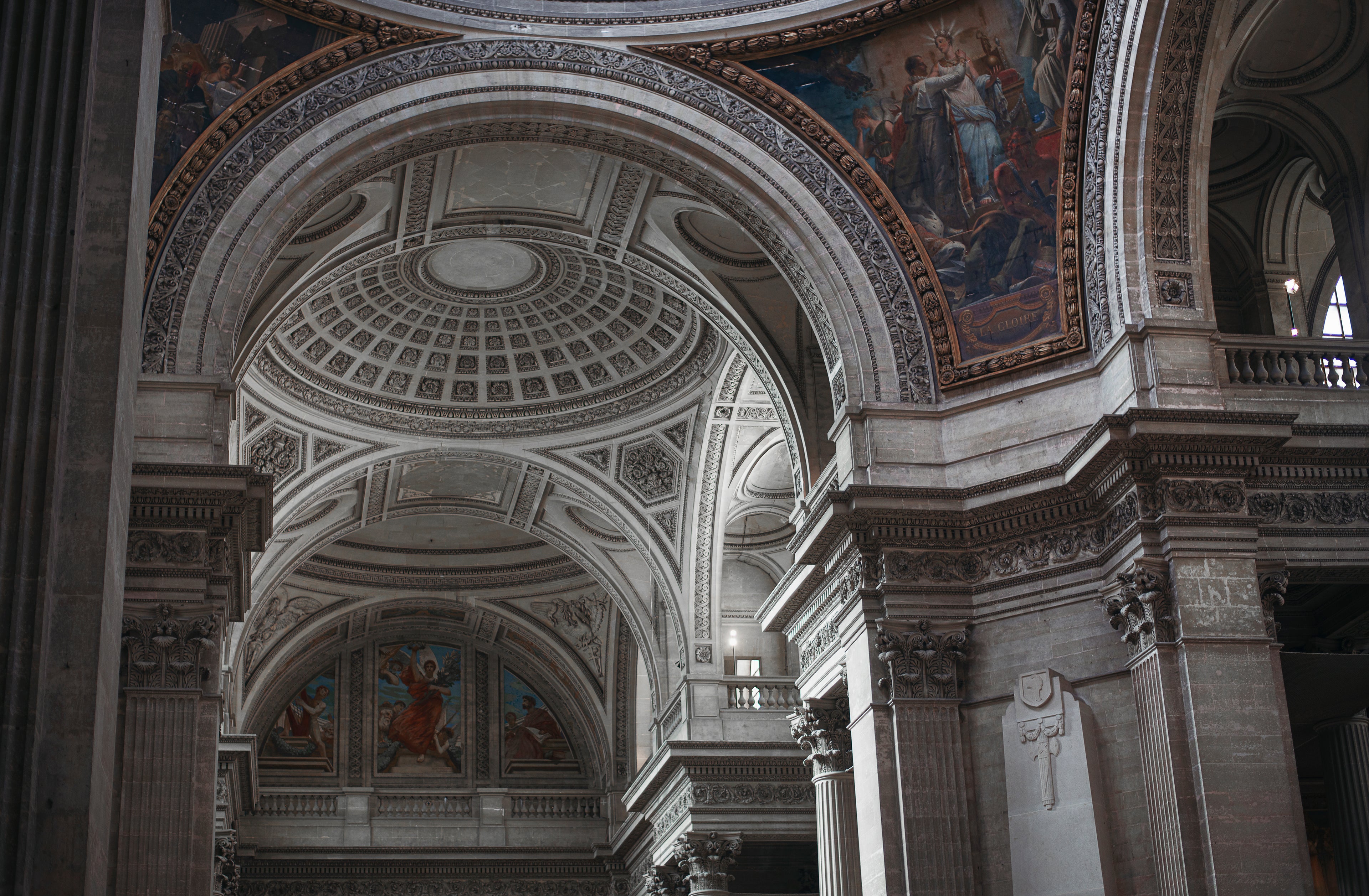 Interior view of a historic old Catholic church featuring ornate Gothic architecture, intricate stained glass windows, gilded altars, and candlelit ambiance for religious and spiritual reflection.