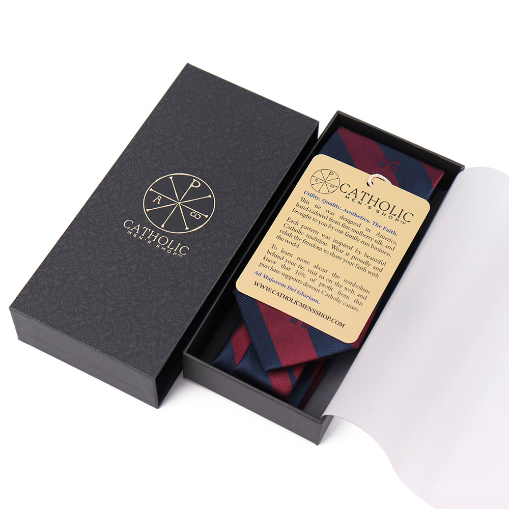 Catholic brand tie in a black box with a card on a white background. Catholic Men's Shop premium men's gift.
