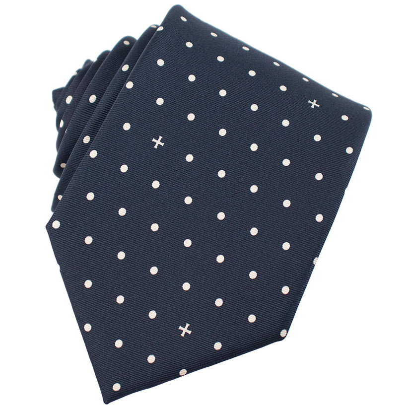 Navy blue tie with white polka dot pattern on a white background
