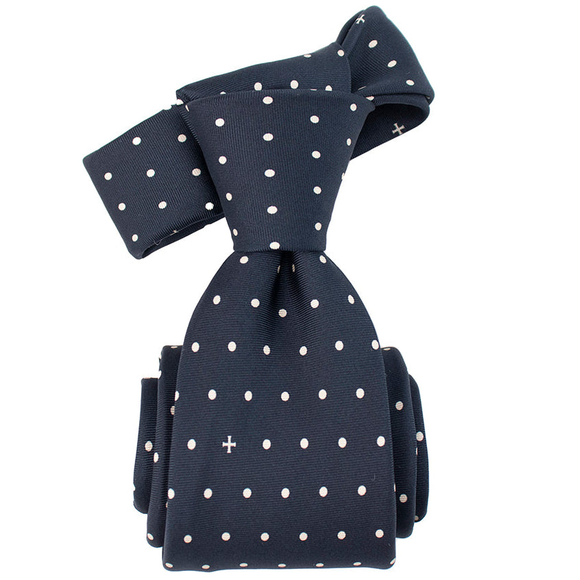 Navy blue tie with white polka dots on a white background