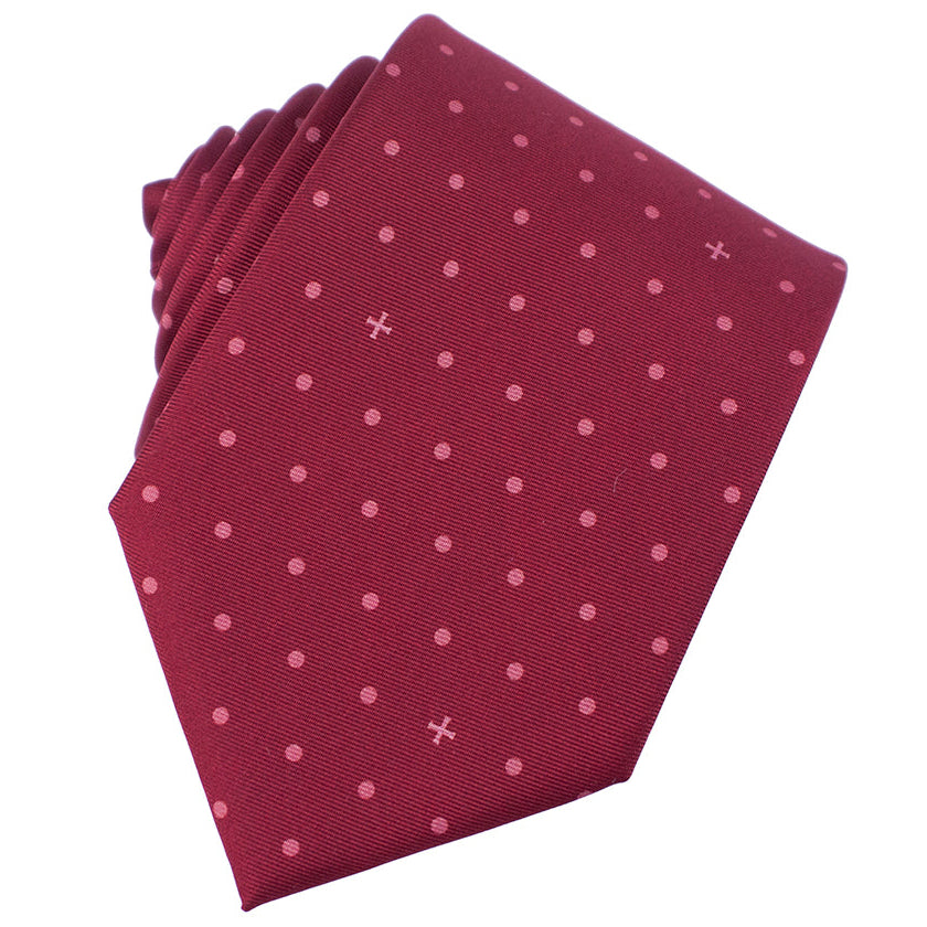 Folded burgundy tie with pink polka dots on a white background