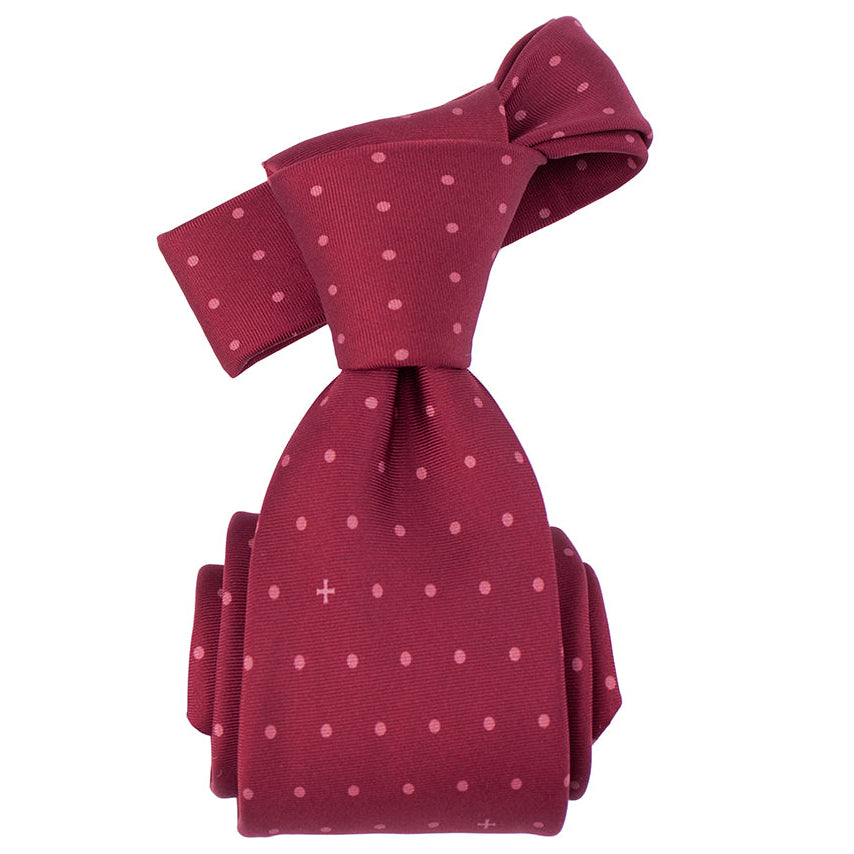Maroon tie with white polka dots on a white background