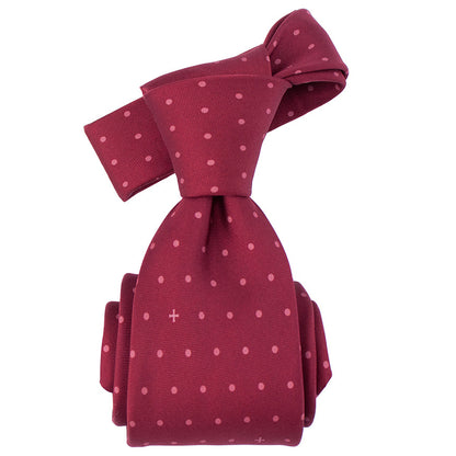 Maroon tie with white polka dots on a white background