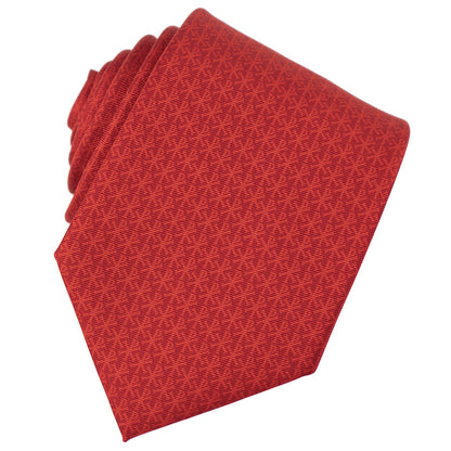 Folded red patterned tie on a white background