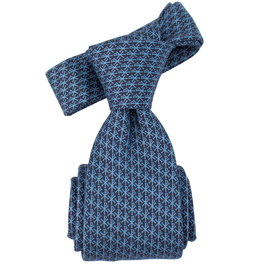 Blue patterned tie on a white background. Chi Rho micropattern premium silk Catholic necktie.
