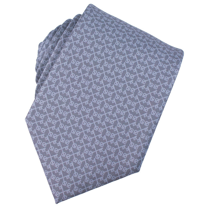 Folded blue patterned fabric on a white background. St Peter's Keys micropattern Catholic Necktie, silk.