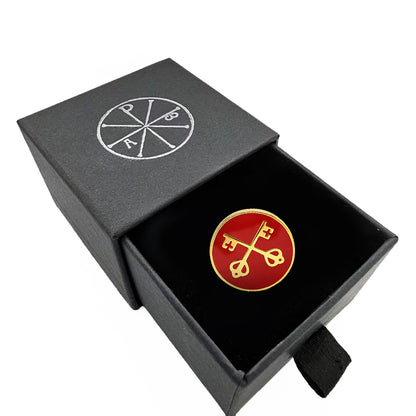 Red and gold emblem in a black box with a logo on a white background