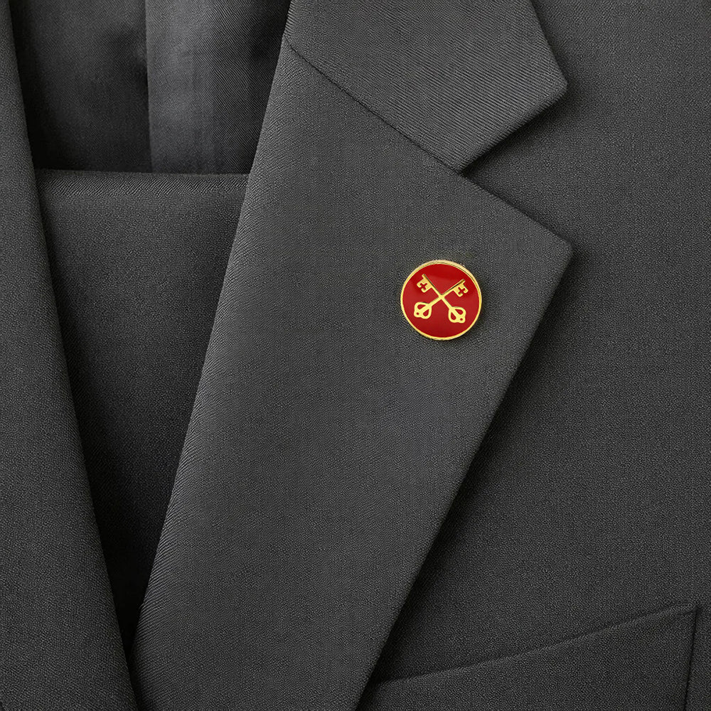 Close-up of a dark gray suit jacket with a red and gold emblem on the lapel.