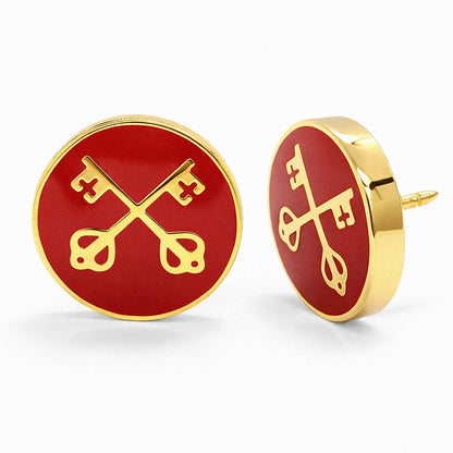 Red round lapel pins with gold key designs on a white background